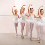 Group of six little ballerinas posing together with back to camera. They are good friend and amazing dance performers